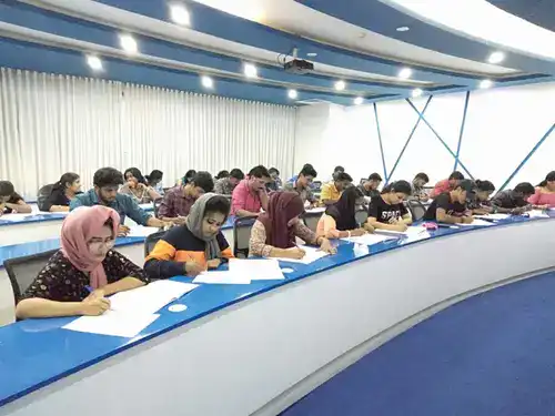 IHRA students working through HR reporting and analytics exercises in a classroom session
